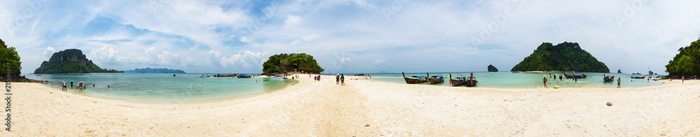 Panorama of Chicken Island tourist beach, with boats anchored and rock formations, Thailand