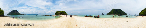 Panorama of Chicken Island tourist beach, with boats anchored and rock formations, Thailand