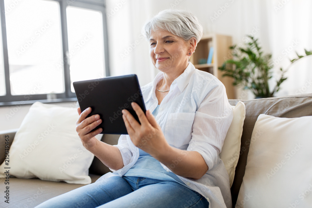 technology, age and people concept - happy senior woman with tablet pc computer at home technology, age and people concept - happy senior woman with tablet pc computer at home