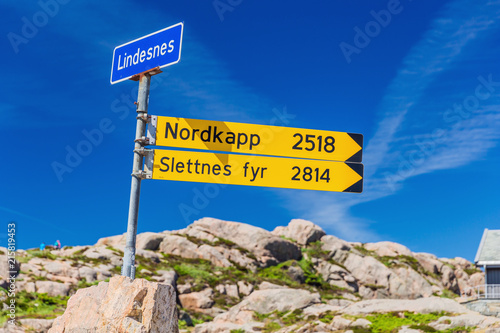 Signpost near the Lindesnes lighthouse indicating the distance to the North Cape and the northernmost lighthouse photo