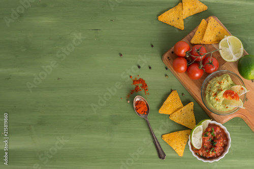 tortilla chips with dips, spices and vegetables