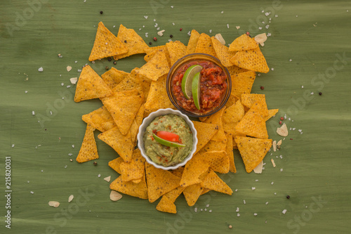 tortilla chips with dips, spices and vegetables