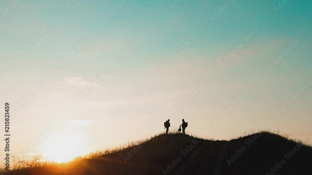 two men tourists hikers silhouette go to the mountains sunset travel slow motion video. Traveler successful young men walking lifestyle on top of Mountain and waiting for sunrise. travel tourists in two men tourists hikers silhouette go to the mountains sunset travel slow motion video. Traveler successful young men walking lifestyle on top of Mountain and waiting for sunrise. travel tourists in