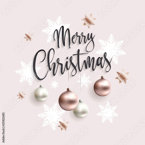 Xmas card with rose gold balls. Merry christmas calligraphic inscription ornate toys. Pink clean background. Golden xmas balls. © radionastya