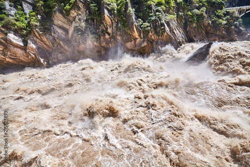 Turbulent muddy mountain river, Tiger Leaping Gorge, China.