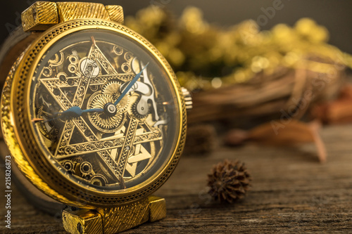 Vintage skeleton watch with Star of David on wood background