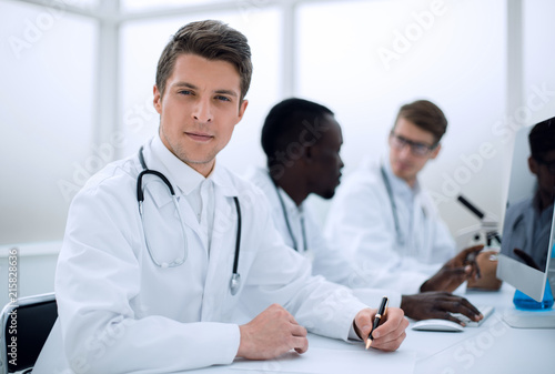 doctor writing down the data in the laboratory journal