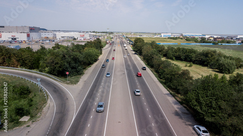 Aerial shot of a car moving on highway overpass  ringway  roundabout