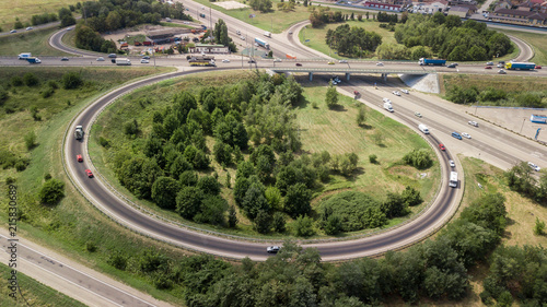 Aerial shot of a car moving on highway overpass, ringway, roundabout