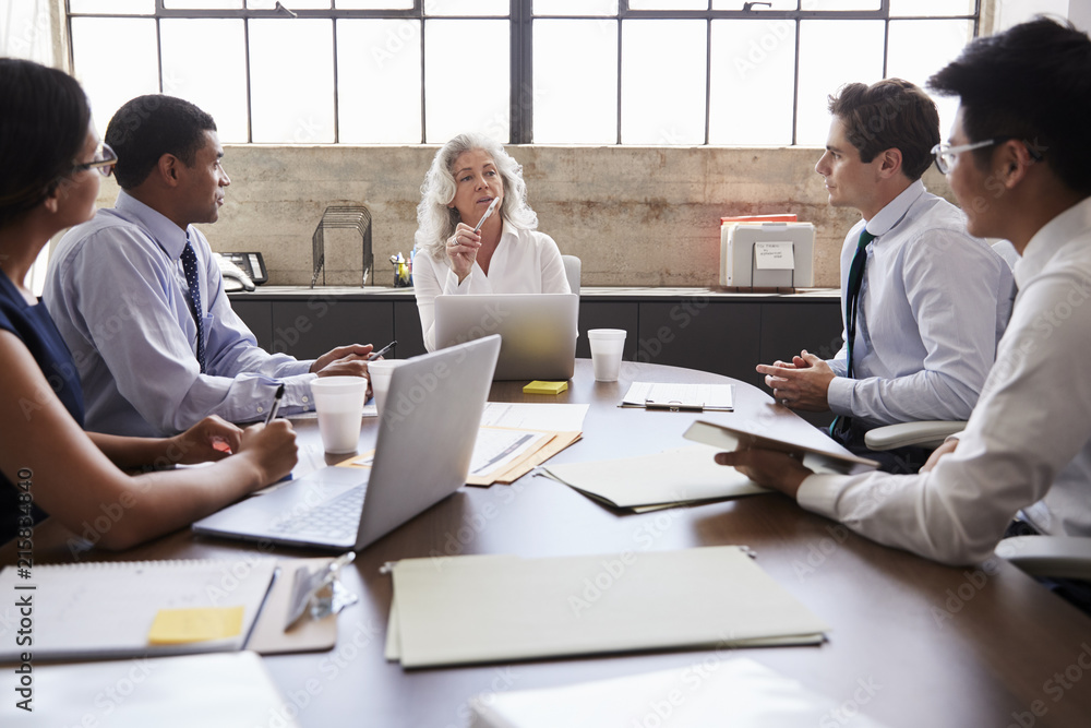 © Monkey Business - Female manager and business team in brainstorm, close up