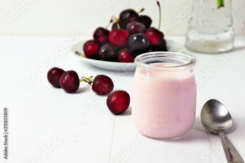 Cherry yogurt in glass, with fresh cherries