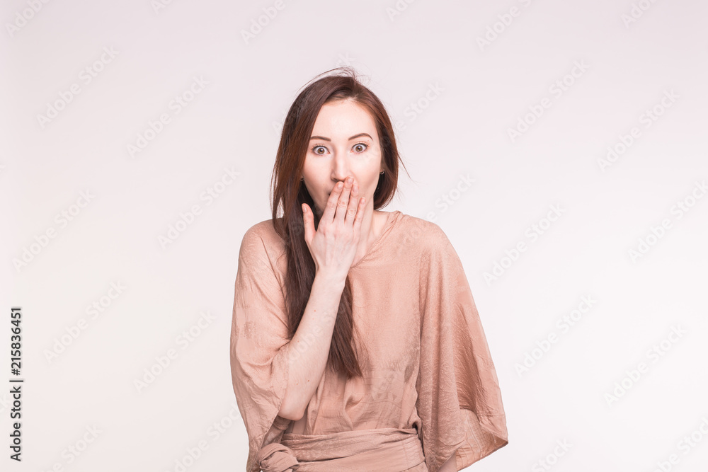 Surprise, shame and people concept - Asian brunette woman covering her mouth Surprise, shame and people concept - Asian brunette woman covering her mouth