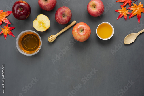 Table top view aerial image of decorations Jewish holiday Rosh Hashana background concept.Flat lay of variety apple & honey with maple leaf on modern rustic grey wood.Free space for design text.