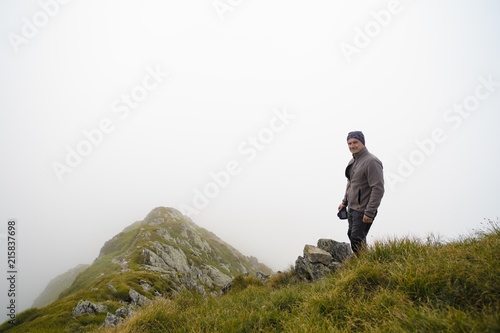 portrait with a tourist on the mountain with a fog