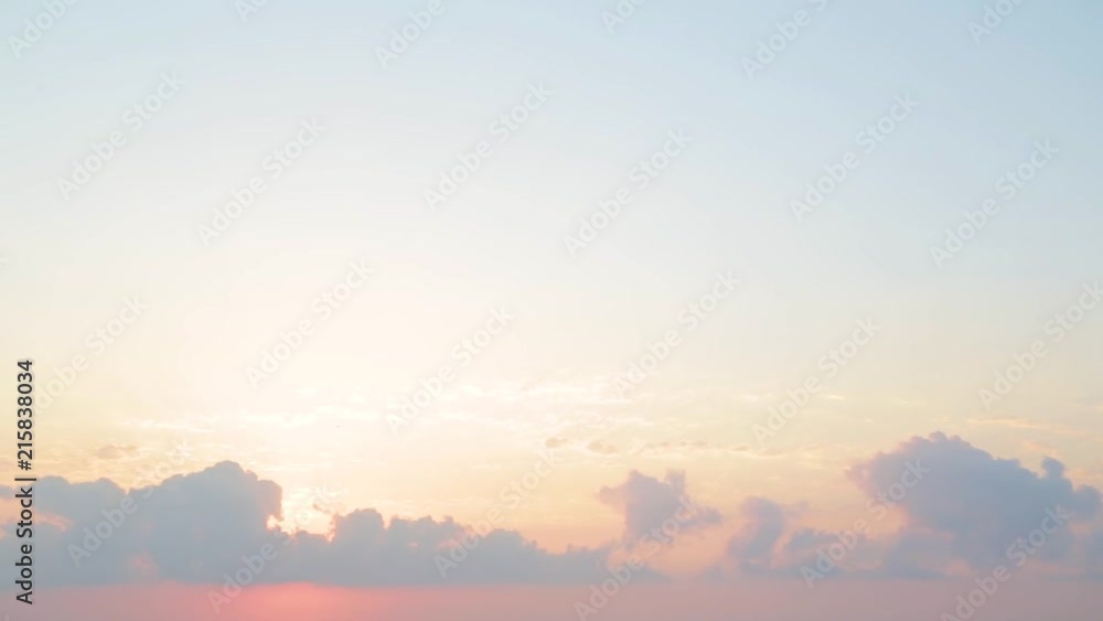 Beautiful golden sky with fluffy calm clouds and sun hiding behind them over sea water. Natural scenic background. Real time full hd video footage. Beautiful golden sky with fluffy calm clouds and sun hiding behind them over sea water. Natural scenic background. Real time full hd video footage.