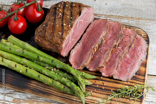 Fresh grilled meat.Grilled beef steak slicing medium rare , asparagus, tomato