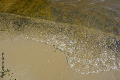 Yellow river sand with a river wave of the Dnieper