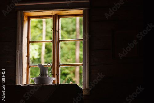Old vintage window, ceramic jug in foreground