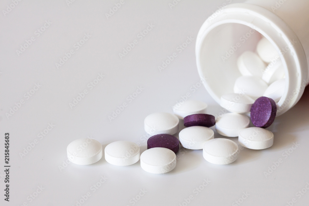 White pills and pill botle. White pills and pill botle.