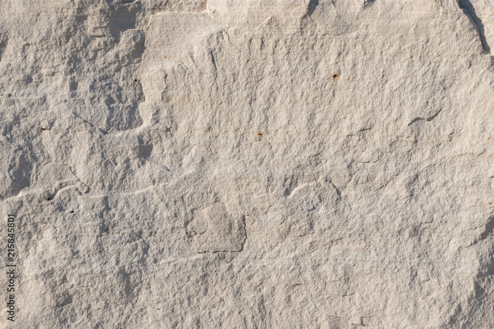 Background geology closeup limestone rock face showing weathered strata