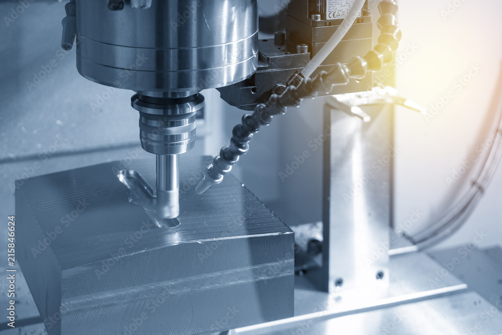The CNC milling machine cutting the mold part in roughing process with the index-able radius end-mill tool.Hi-technology manufacturing process. The CNC milling machine cutting the mold part in roughing process with the index-able radius end-mill tool.Hi-technology manufacturing process.
