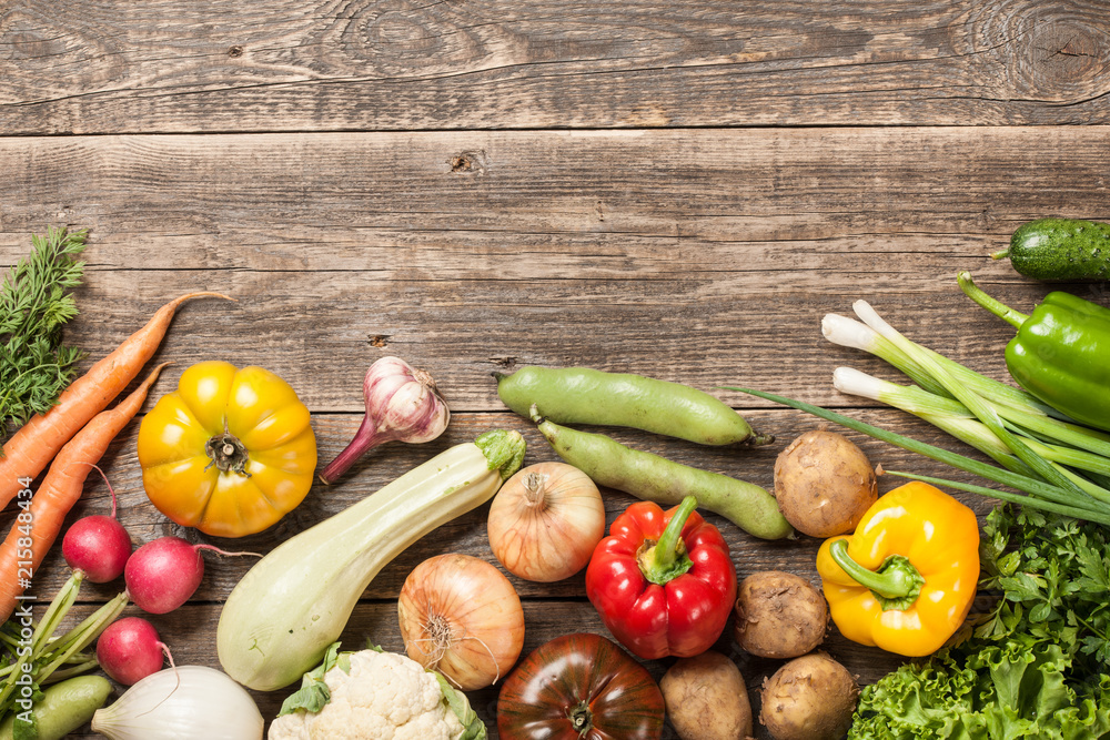 Fotografie Assorted organic fresh vegetables on wooden table
