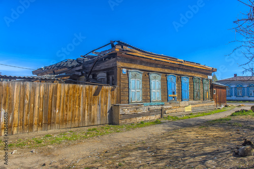 Abandoned wooden house on the street in the center of Irkutsk photo