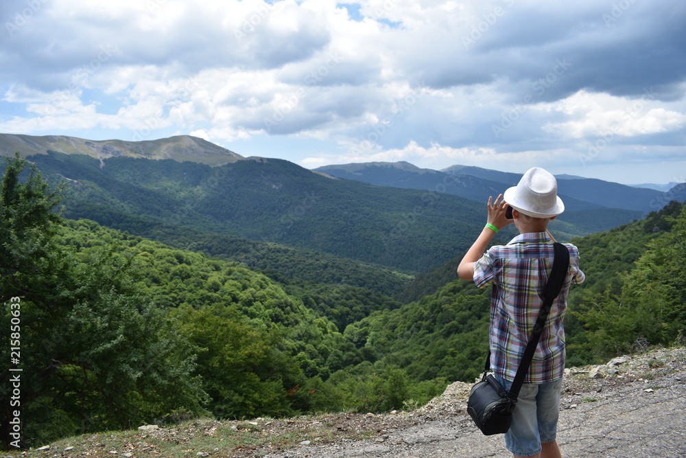 The young traveler photographs mountains The young traveler photographs mountains