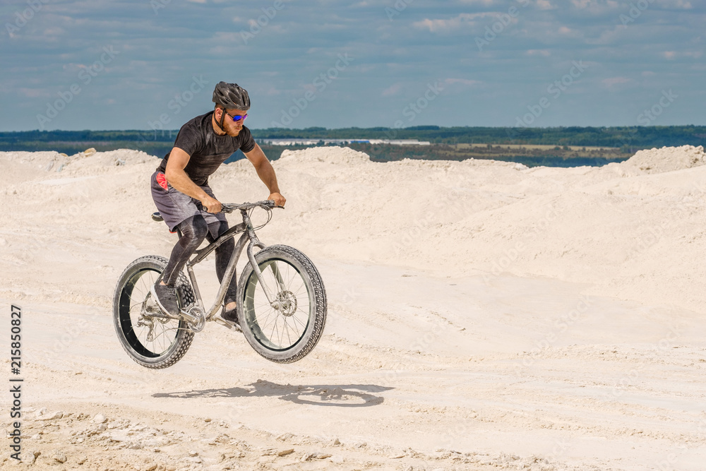 Training a bicyclist in a chalky quarry. A brutal man on a fat bike. Training a bicyclist in a chalky quarry. A brutal man on a fat bike.