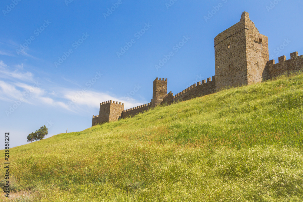 Towers and walls of the Genoese fortress on a high green hill.The City Of Sudak.Crimea.