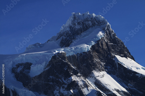 Snowy mountain summit with blue sky