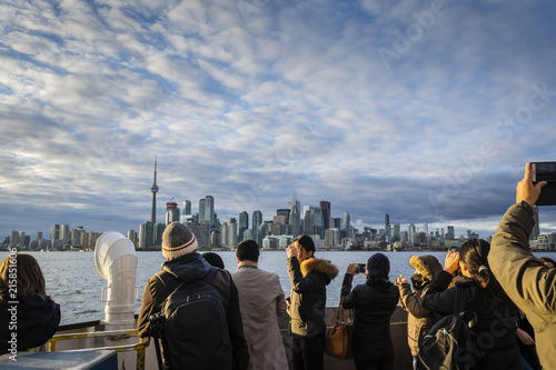 Group of people on Ferry to Toronto Islands looking at Toronto skyline