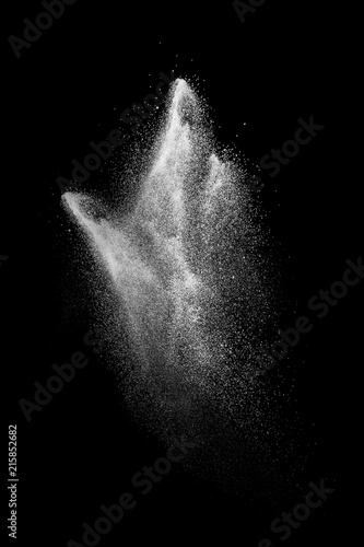 Abstract white powder explosion against black background.