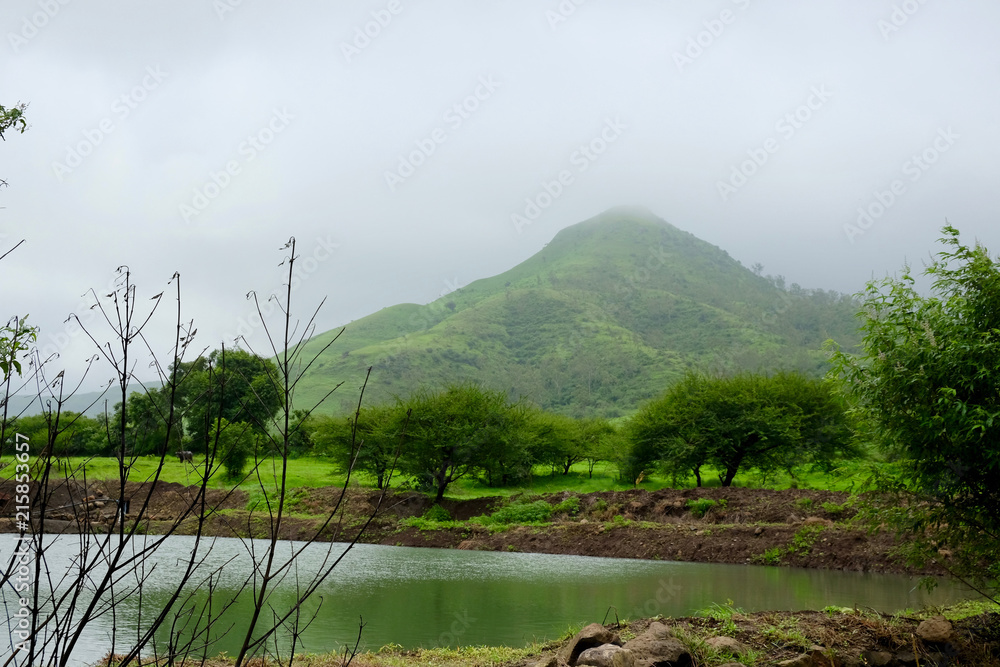 Obraz premium lush green landscape of mountain and hills in monsoon season, Purandar, Maharashtra, India