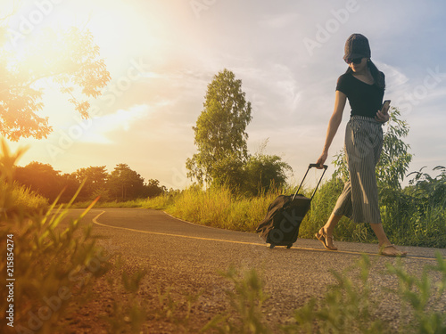 Traveling girls are traveling with luggage. Through nature tourism. (Travel ideas)