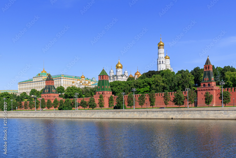 Moscow Kremlin on a Moskva river background against blue sky in sunny summer morning