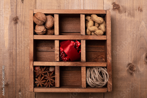 Wooden box with Christmas decorations on wooden table. Rustic style. Top view. photo