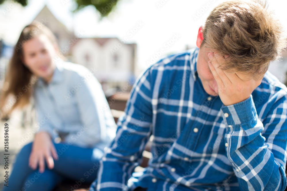 Unhappy Teenage Couple Having Argument In Urban Setting Unhappy Teenage Couple Having Argument In Urban Setting