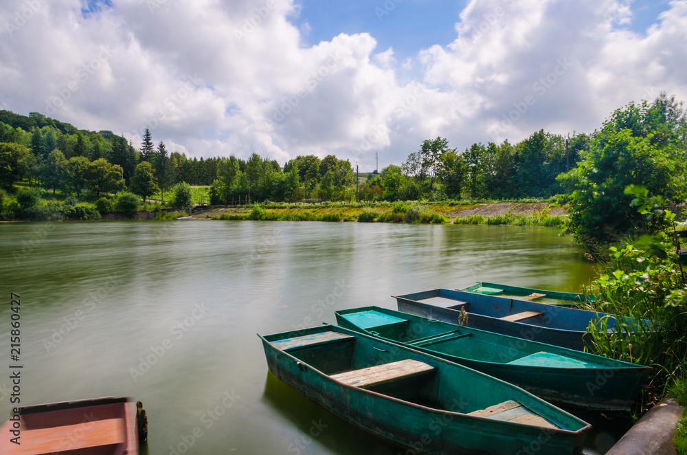 Wooden pier or jetty and a boat on lake sunset and sky reflection water. Wooden pier or jetty and a boat on lake sunset and sky reflection water.
