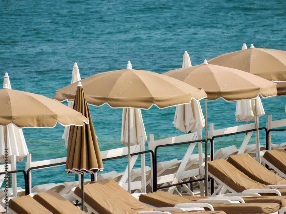Cannes - Beige umbrellas on a beach