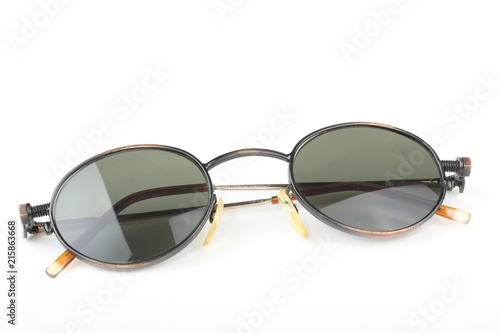 Old sunglasses with metal frame in steampunk style on a white background