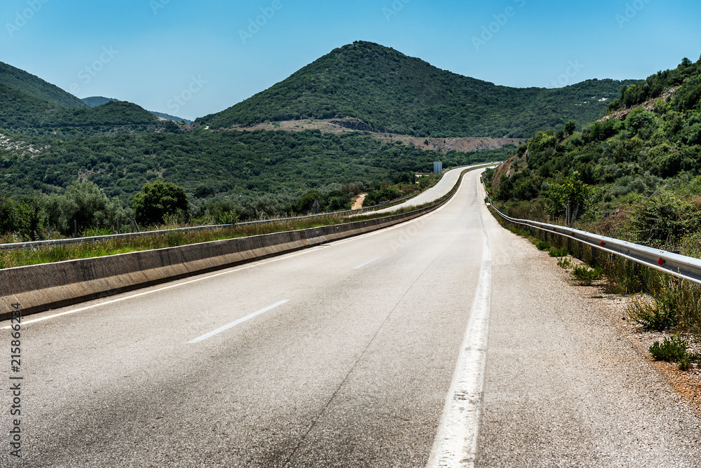 Motorway or Highway winding among hills through a rural landscape