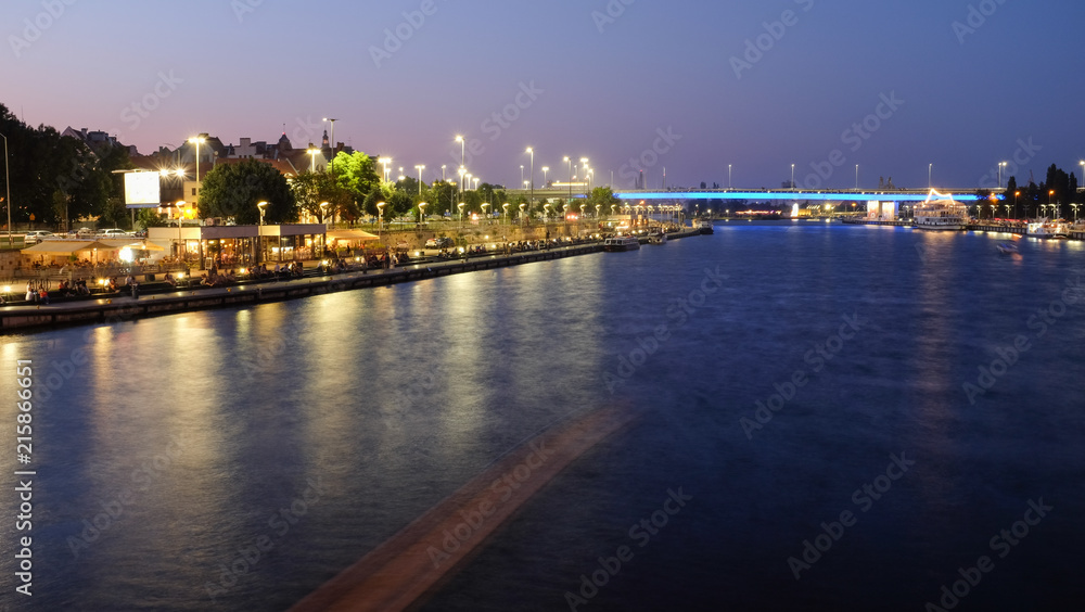 Szczecin. Evening view of the river, the old town and the fashionable waterfront among the inhabitants as well as tourists.