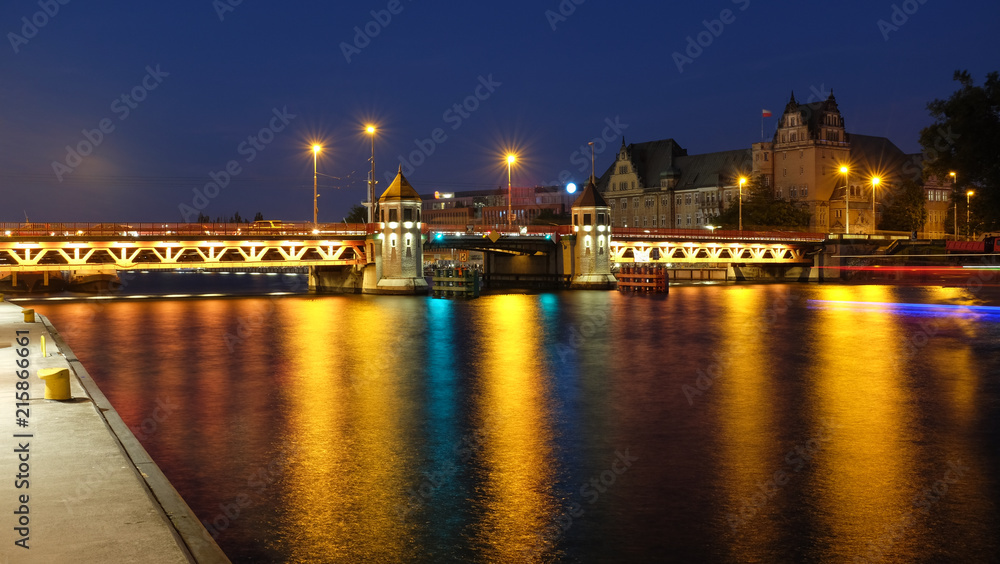 Szczecin. night view of the historic long bridge over the Odra river.