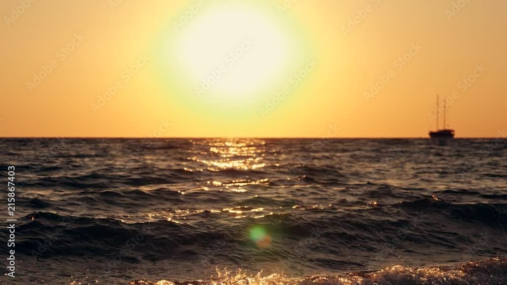 Sailing yacht in the open sea at sunset, rocking on the waves Sailing yacht in the open sea at sunset, rocking on the waves