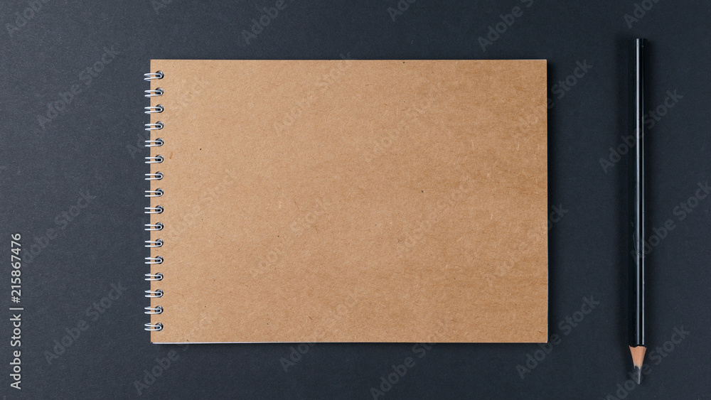 Blank notebook with pencil on black background. Workplace. Copy space. Minimal concept. Top view. Flat lay Blank notebook with pencil on black background. Workplace. Copy space. Minimal concept. Top view. Flat lay