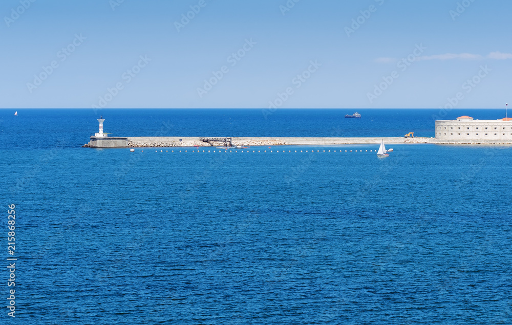 Russia, the peninsula of Crimea, the city of Sevastopol. 06/10/2018: Konstantinovskaya battery and a lighthouse at the entrance to the Sevastopol Bay