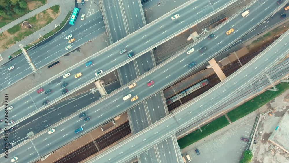 flight of the camera over the traffic junction. Aerial top view of road junction in Moscow from above, automobile and train traffic and jam of many cars, transportation concept. flight of the camera over the traffic junction. Aerial top view of road junction in Moscow from above, automobile and train traffic and jam of many cars, transportation concept.
