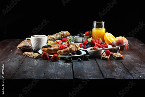 breakfast on table with waffles, croissants, coffe and juice.