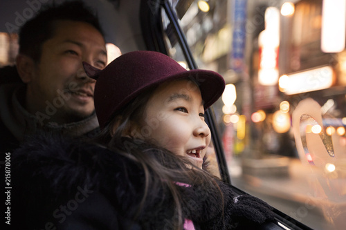 Father and daughter look out taxi window
